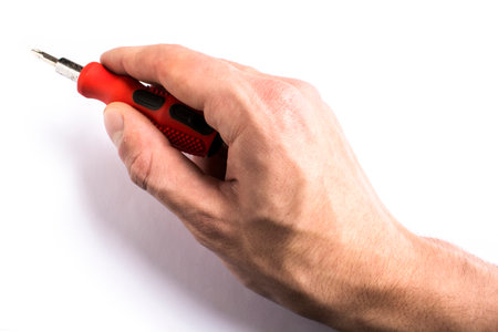 man of man hold a screwdriver with handle rubber of red color on the white backgroundの写真素材