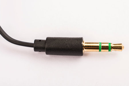 3.5mm headphone jack with wire lies on a white background isolate