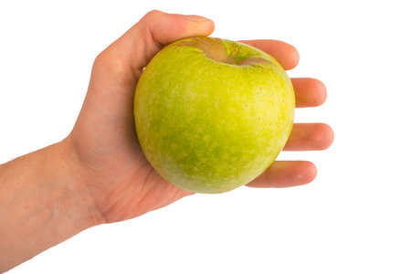 in a hand a green apple isolated on white isolated backgroundの写真素材