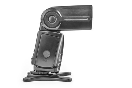 Black camera flash on the stand isolate