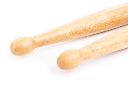 Two wooden drum sticks lying on each other isolated on white backgroundの写真素材