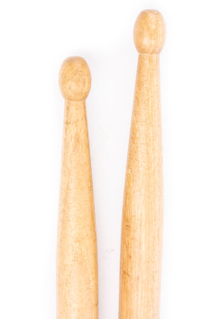 Two wooden drum sticks lying on each other isolated on white backgroundの写真素材