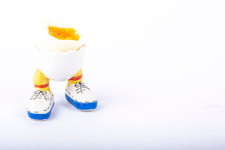 boiled egg open half in stand in the form of legs isolateの写真素材