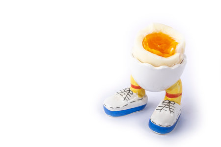 boiled egg open half in stand in the form of legs isolateの写真素材