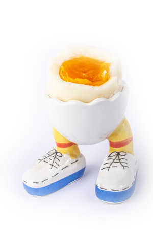 boiled egg open half in stand in the form of legs isolateの写真素材