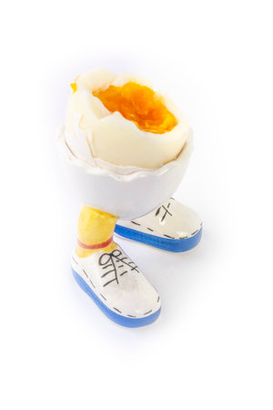 boiled egg open half in stand in the form of legs isolateの写真素材