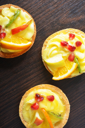 cream cake with colored fruit in a basketの写真素材