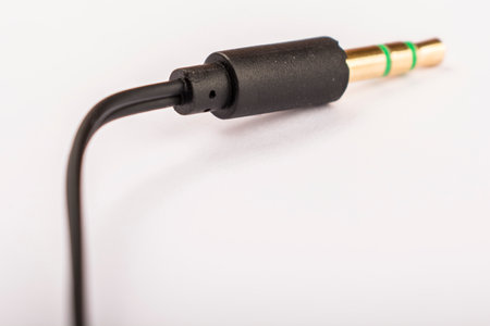 3.5mm headphone jack with wire lies on a white background isolate