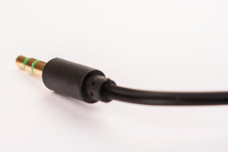 3.5mm headphone jack with wire lies on a white background isolate