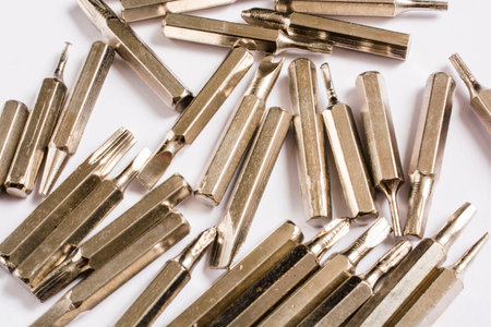 different bits for screwdrivers scattered on white backgroundの写真素材