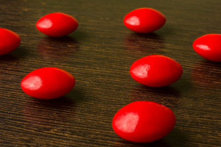 red vitamins pills on a wooden backgroundの写真素材
