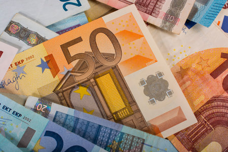 a small pile of paper euro bills as part of the trading system