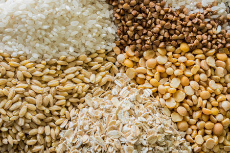 raw buckwheat, peas and rice background texture
