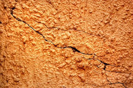 texture of the old stucco wall with cracks の写真素材