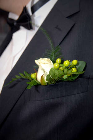 wedding buttonhole with rose on mans suite