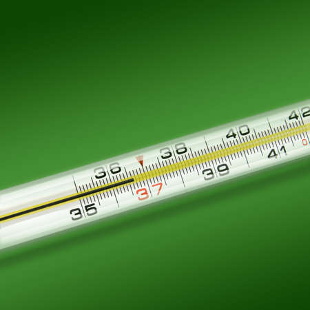 close-up thermometer on green background