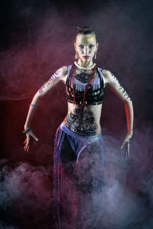 tribal girl dancing in fogの写真素材