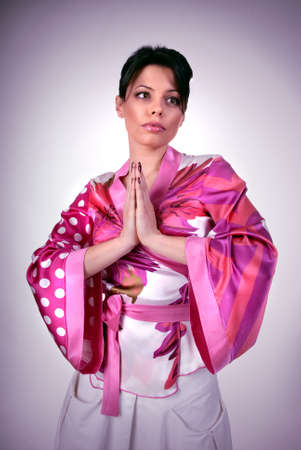 Atrractive girl in kimono prayの写真素材