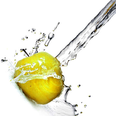fresh water splash on yellow apple isolated on whiteの写真素材