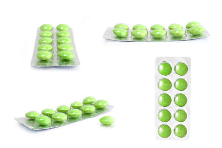 packs of green tablets isolated on whiteの写真素材