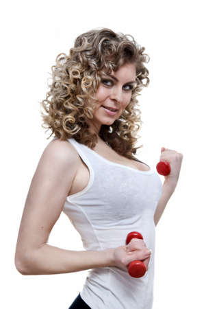 Portrait of young sexy woman holding dumbbells isolated on whiteの写真素材