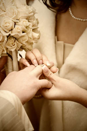 puttting on a wedding ring. stylized photoの写真素材