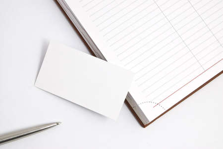 Empty business card with diary and pen isolated on whiteの写真素材