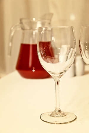 glass goblet and red beverage on the tableの写真素材