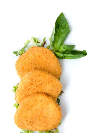spicy cheese cakes with green leaves on the plate