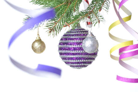Christmas balls and decoration on fir tree branch isolated on whiteの写真素材