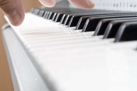 hand playing music on the piano