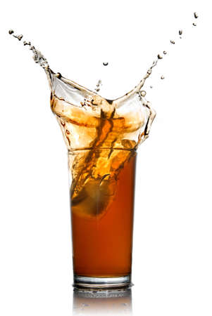 Beautiful splash of cola in glass isolated on whiteの写真素材