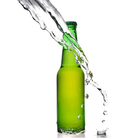 Green beer bottle with water splash isolated on whiteの写真素材