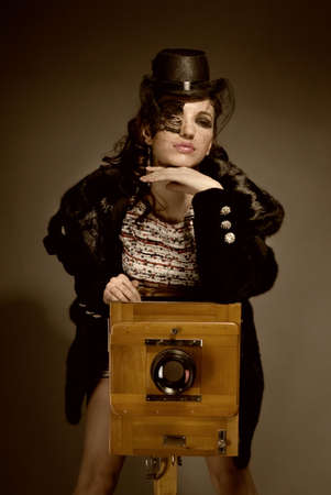 Old-style portrait of lady with vitage camera