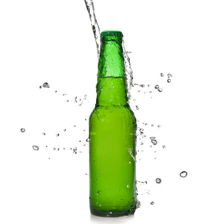 Green beer bottle with water splash isolated on whiteの写真素材