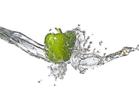 fresh water splash on green sweet pepper isolated on white の写真素材