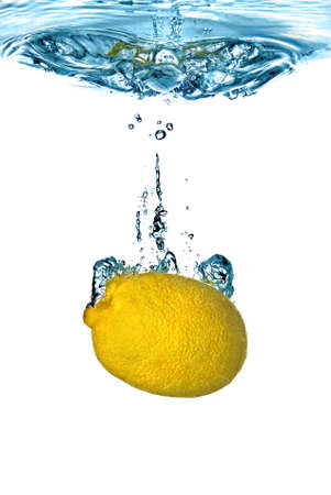 Fresh lemon dropped into water with bubbles isolated on whiteの写真素材