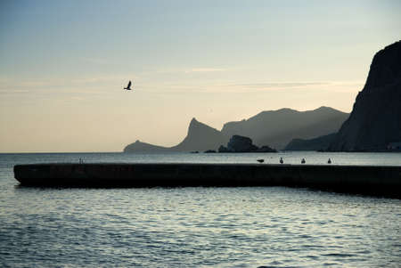 landscape with sea and mountains on sunsetの写真素材