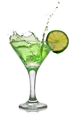 Green alcohol cocktail with splash and green lime isolated on whiteの写真素材
