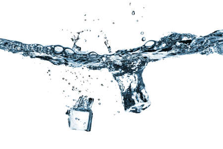 ice cubes dropped into water with splash isolated on whiteの写真素材