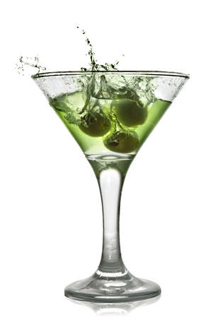 Green alcohol cocktail with splash isolated on whiteの写真素材