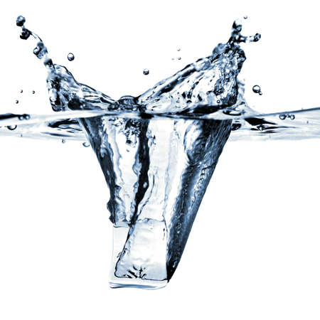 ice cube dropped into water with splash isolated on whiteの写真素材