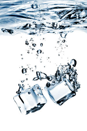 ice cubes dropped into water with splash isolated on whiteの写真素材