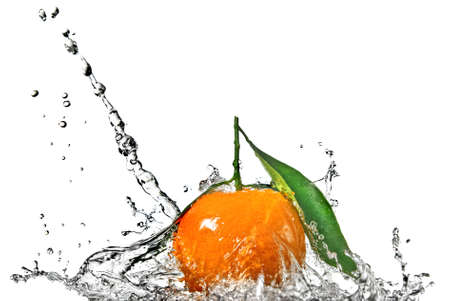 Tangerine with green leaves and water splash isolated on whiteの写真素材