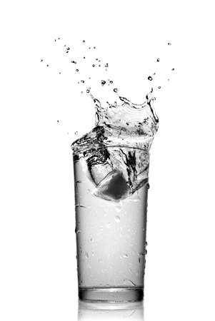 water splash in glass isolated on whiteの写真素材