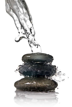 Spa stones with water splash isolated on whiteの写真素材