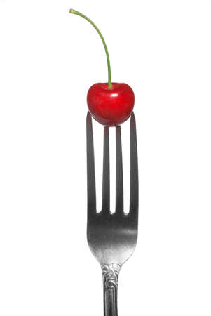 red cherry on fork isolated on whiteの写真素材