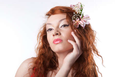 Portrait of beautiful woman with spring flowers on white