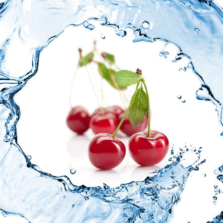 Red cherry with leaves and water splash isolated on whiteの写真素材