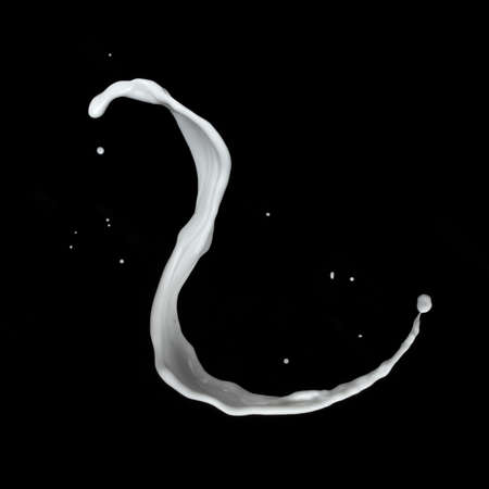 milk splash isolated on black backgroundの写真素材